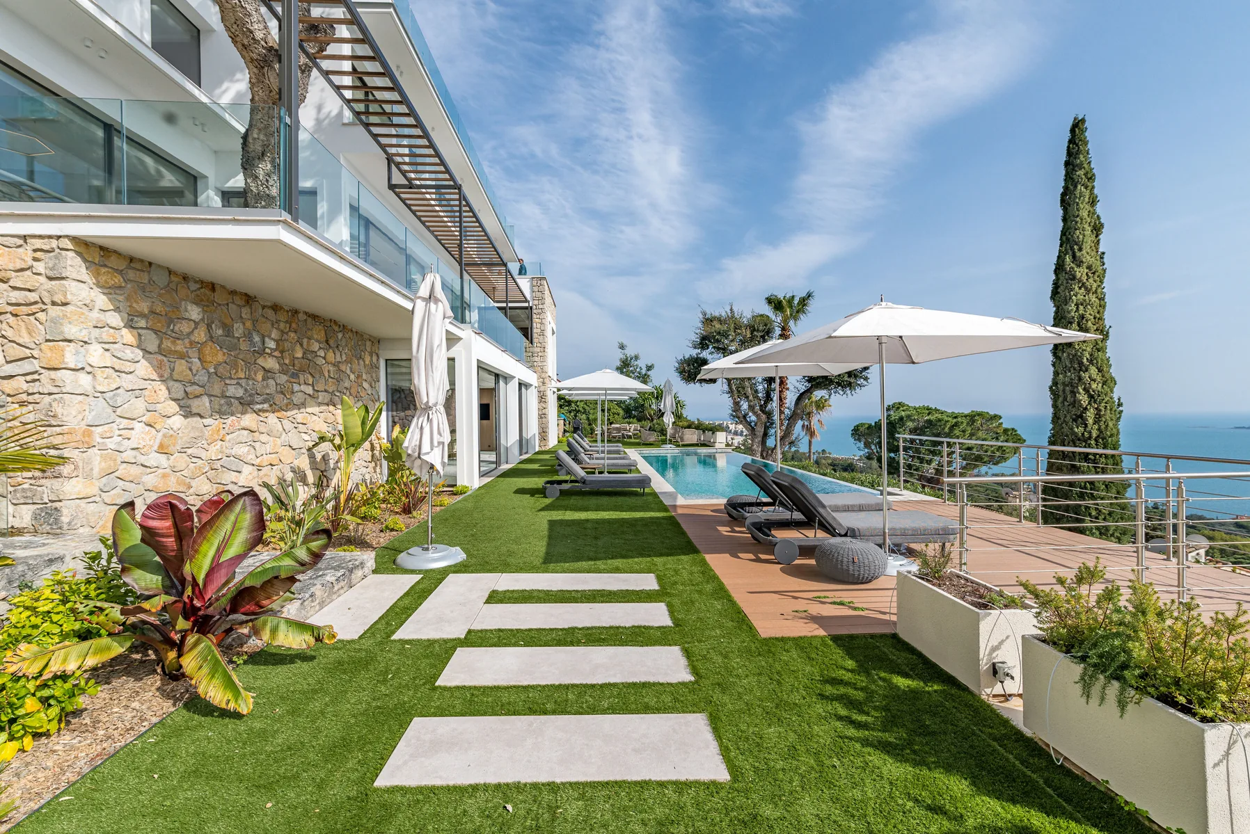 Jardin paysagé, pas japonais et terrasse bois donnant sur la piscine